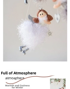 Detailed close-up of a white plush Christmas angel ornament with silver wings and crown
