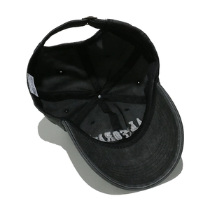 Detail of CALIFORNIA embroidery and adjustable metal buckle on washed cotton baseball cap