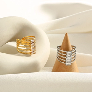 Macro detail of multi-layer gold and silver rings with baguette-cut zircons