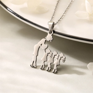 Detailed view of silver necklace pendant featuring a mother and three children silhouette
