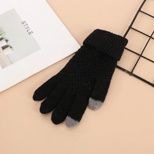 Detailed view of black knitted winter glove showing touchscreen grey tips and ribbed cuff