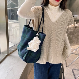 Minimalist green plaid wool shoulder bag featuring a cute white lamb plush keychain charm