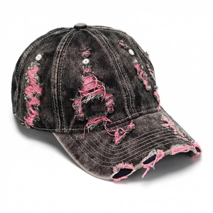 Close-up detail of the distressed vintage denim baseball cap with pink frayed edges