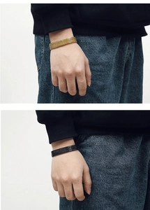 Detailed close-up of men's square dragon bone chain in gold and black stainless steel