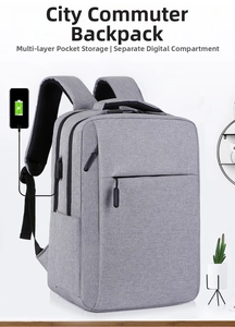 Detail of the gray commute backpack showing external USB charging port and zipper pocket