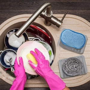 Close-up of pink non-slip silicone gloves and grey textured draining soap tray mat