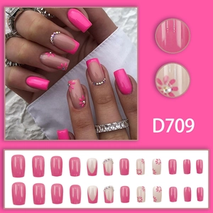 Hot pink press-on nails with floral daisy art and rhinestones in a French square shape