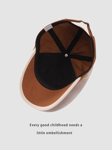 Detail view of the brown bear baseball cap interior showing the size label and stitching