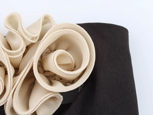 Dettaglio di fiore 3D in chiffon beige su un top corto sexy in rete nera da donna
