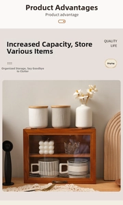 Detail view of a vintage wooden tabletop display cabinet with glass door and tea set