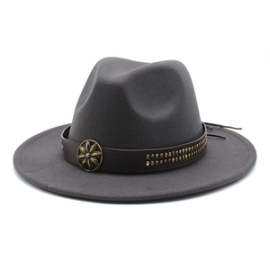 Close-up of dark grey wool fedora with brown leather band and ornate floral metal studs
