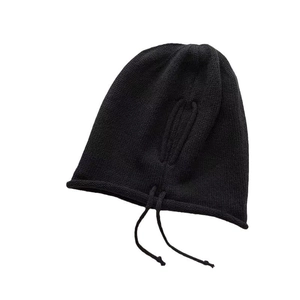 Warm black knitted slouchy beanie for women with drawstring ear protection for winter