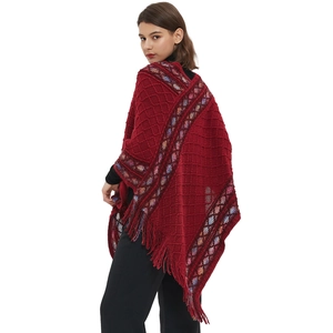 Ethnic knit pullover poncho with tassels and colorful geometric patterns for autumn winter