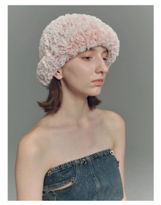 Close-up of pink fluffy faux fur beanie with soft plush texture for winter comfort
