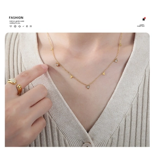 Close-up of 18K gold plated titanium necklace with triangle zircon pendants on a model