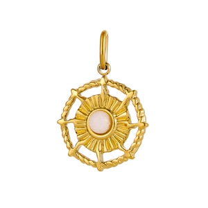 Macro shot of gold circular pendant with white gemstone inlay and woven texture detailing