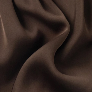 Close-up of premium satin fabric in chocolate brown showing smooth texture and soft pleats
