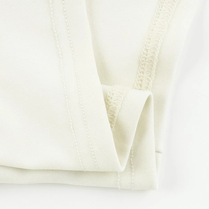 Macro detail of white knitted fabric texture with professional double-needle stitching