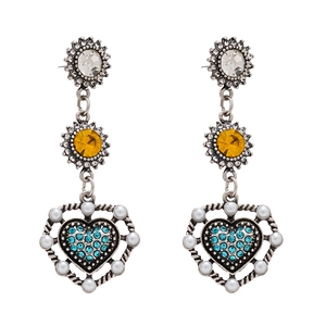 Orecchini vintage a fiore e cuore con strass blu e perle bianche su sfondo bianco puro