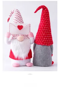 Detail of two Valentine gnomes with knit hats holding heart envelope on white background