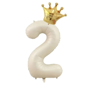 Detail of cream number 2 balloon with gold crown for kids birthday party decoration