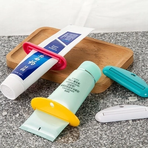 Detail of four colorful manual tube squeezers used for toothpaste and facial cleanser