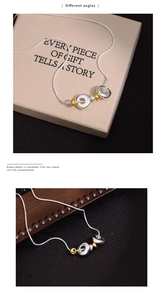 Detailed views showing different angles of the minimalist gold and silver ring necklace