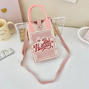 Detailed macro view of pink knit crossbody phone bag with red Holiday text and snap button