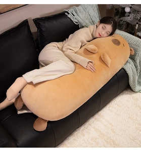 Detailed view of extra long capybara plush pillow on sofa for soft home comfort