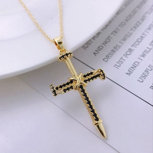 Detail of 14K gold plated cross pendant with micro-paved black zircons and nail design