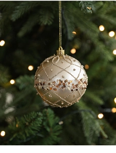 Champagne gold 8cm Christmas ball with glitter lattice hanging on a festive tree branch