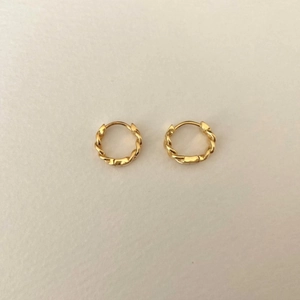 Detailed view of 925 sterling silver twisted hoop earrings with a gold-plated finish
