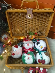 Close-up of 5-piece Christmas socks gift set in spherical baubles within a woven basket