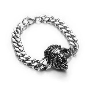 Detailed close-up of a silver-toned punk lion head charm on a chunky cuban link bracelet