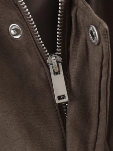 Close-up of premium silver metal zipper and texture on dark brown suede jacket