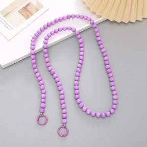 Detailed view of a purple beaded phone lanyard with faceted beads and metal rings