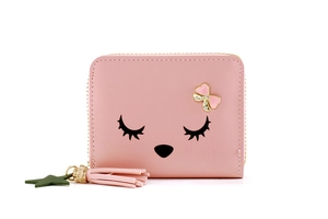 Detailed close-up of pink mini wallet with cartoon face, bow and tassel charms