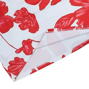 Detailed macro view of red floral print on white fabric with double-needle hem stitching