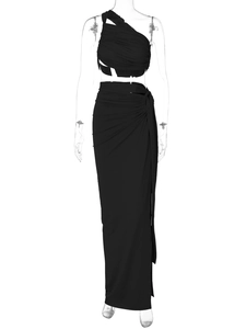 Detail of black two-piece set featuring one-shoulder ruched crop top and high waist wrap skirt