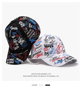 Close-up of black and white baseball caps featuring artistic all-over graffiti patterns