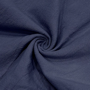 Detailed macro texture of deep blue linen fabric showing fine weave and soft drape