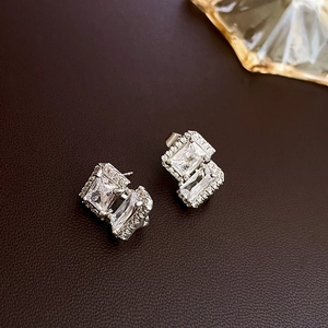 Macro view of rectangular zirconia earrings with silver micro-pave setting detail