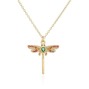 Detail of 18K gold dragonfly pendant with red enamel wings and green pear-cut gemstone