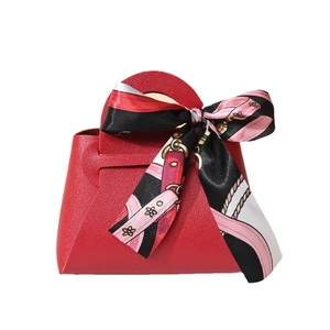 Elegant red faux leather wedding favor gift bag with a decorative silk ribbon handle