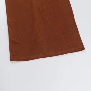 Detailed view of the brown fabric texture and double-stitched hem on this summer maxi dress