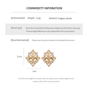 Macro detail showing 18k gold plated iris flower earrings with dimensions and weight