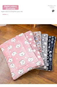 Close-up of soft flannel pet blankets in five colorful patterns on a wooden floor