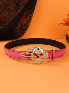 Detail of rose red punk belt with skull buckle and silver rivets on orange background
