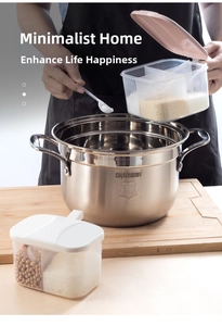 Close-up of a three-compartment plastic seasoning box with spoons in a kitchen setting