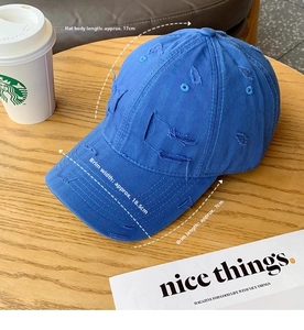 Detailed top view of a blue distressed baseball cap with vintage worn-out details